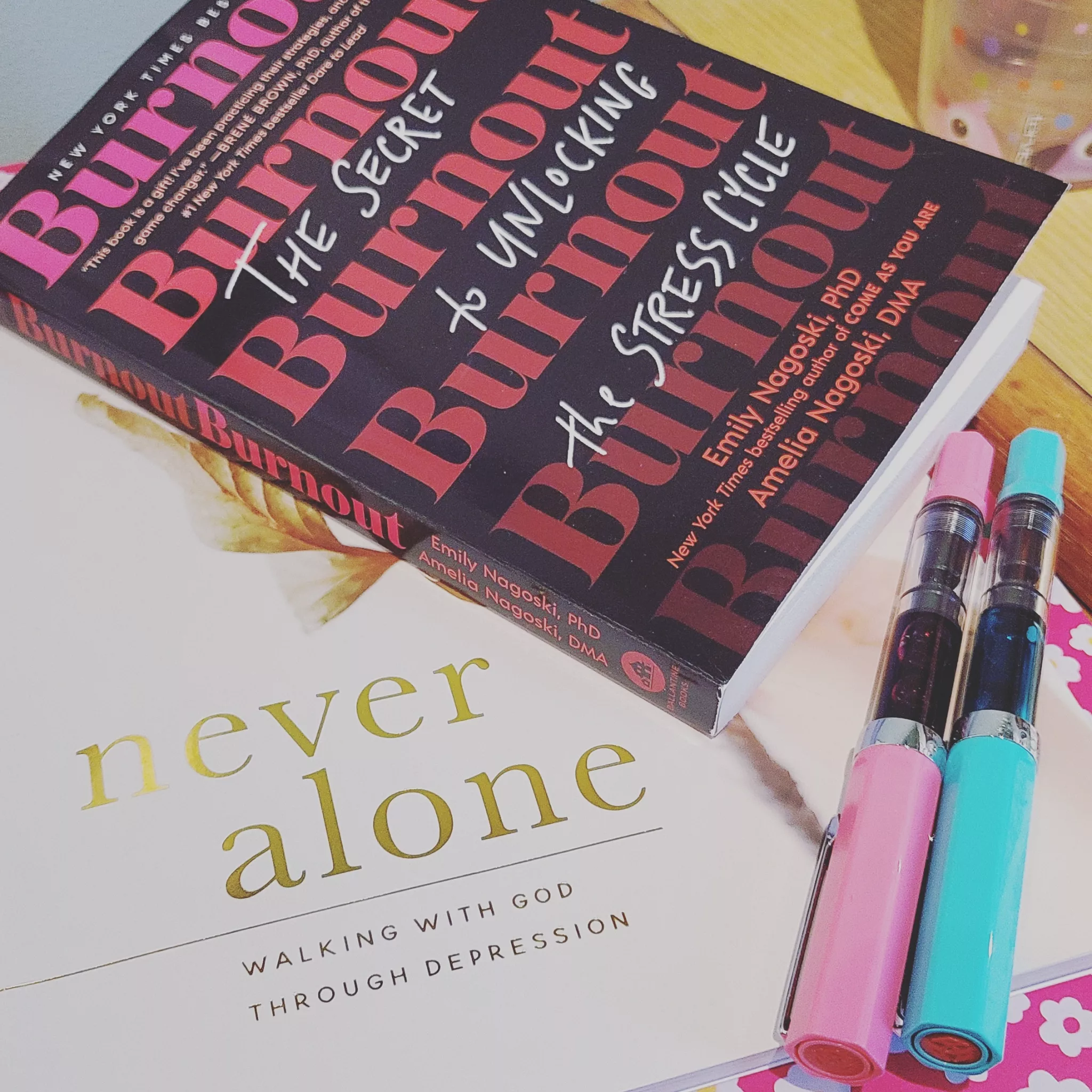 My current #AmReading: Burnout: The Secret to Unlocking the Stress Cycle by Emily Nagoski, PhD, and Amelia Nagoski, DMA, and Never Alone: Walking With God Through Depression by Aubrey Coleman & Joy Woo for The Daily Grace Co